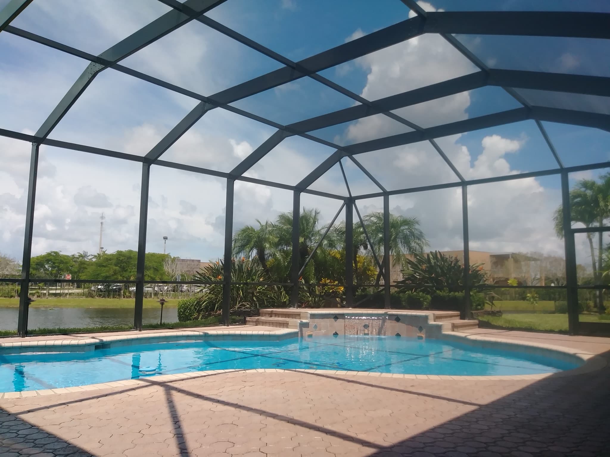 Parkland pool enclosure with a modified mansard roof